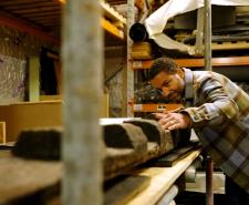 Sean Fletcher inspecting a large piece of timber