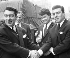 Ronnie and Reggie Kray lock hands as they celebrate being acquitted