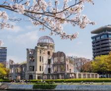 The Hiroshima Peace Memorial in the 21st century with cherry blossoms in the foreground