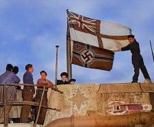 Seamen raise the White Ensign over a captured U-boat (colourised)
