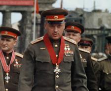Georgy Zhukov wearing a medal in front of the Brandenburg Gate in Berlin