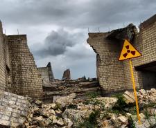 Dilapidated building near Chernobyl with a nuclear warning sign