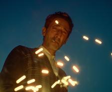László Tóth (portrayed by Adrien Brody in 'The Brutalist') watches sparked embers with a cigarette in his mouth