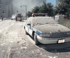 A NYPD car covered in debris and ash, following the 9/11 terrorist attacks