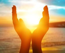 Hands cupping the setting sun