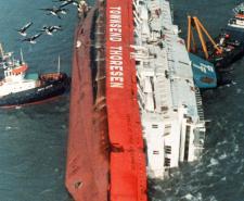 A photograph showing two tugs moored alongside the Townsend-Thoresen ferry 'Herald of Free Enterprise' which capsized on the 6th March 1987