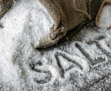 A photograph of a bag of salt with the word 'Salt' spelt out in the salt